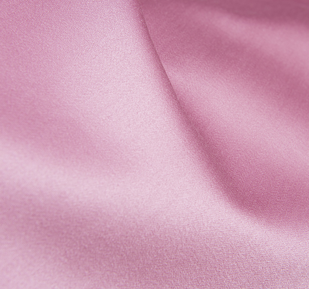 Preferring natural fabrics as the elegant pink Le Rú satin of virgin wool fabric with a soft, luxurious sheen and delicate texture, perfect for upscale fashion designs.